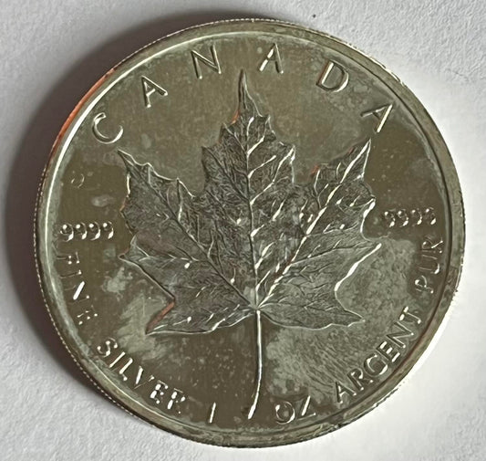 Random Year Canadian Maple Leaf 1 oz Silver Coin in Capsule (note: with heavy milk spots and toning)